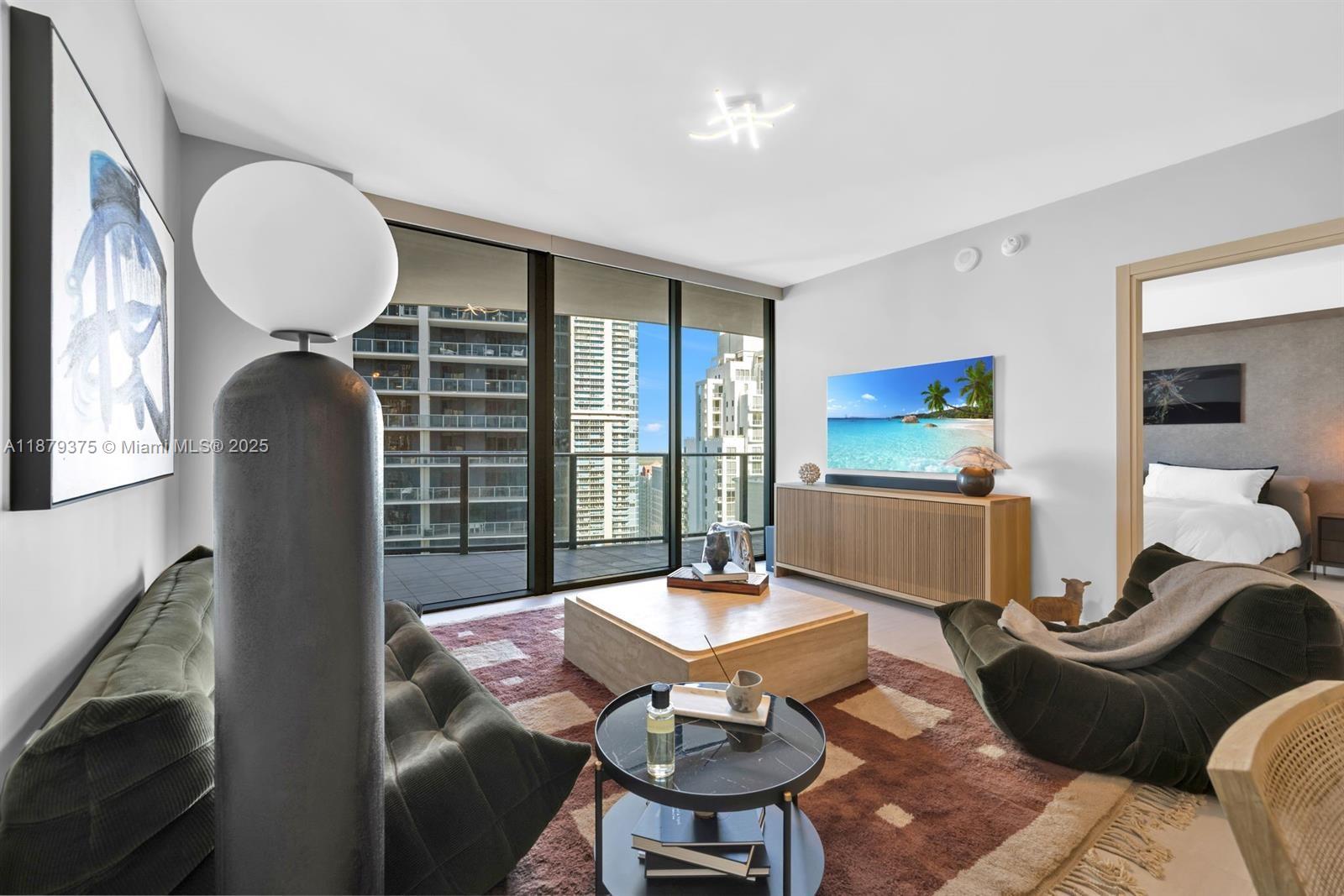 1 bedroom, 2 Bath with an enclosed den including a built-in murphy bed. The kitchen features all Miele appliances & cooking island. Marble in baths, separate tub & shower; energy efficient impact resistant floor to ceiling windows and an enhanced insulation sound proofing between units; stunning views of the Miami’s skyline. Amenities include the 64th floor rooftop pool with a spa, Steam, sauna, and locker facilities and 6,300-square-foot gym with a Pilates, yoga, aerobics studio, and a juice bar. Includes a lap pool and children’s pool on the 18th floor, a movie theater, billiards room, and electric car charging stations.