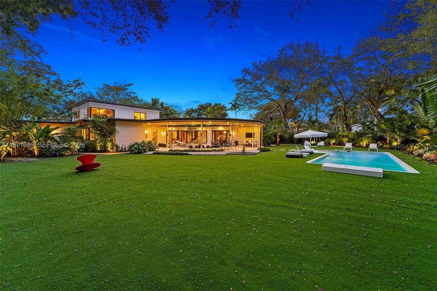 Shoreland – The Revitalized Panorama House.  A rare opportunity to own one of Miami Shores’ most architecturally significant estates. Originally designed in 1950 by noted architect Joseph DeBrita, this iconic midcentury modern residence has been comprehensively reimagined by Shoreland Group.  Set on a 21,450 SF parcel—among the largest in the village—the 5,348 SF home is positioned beneath mature oaks to maximize privacy and outdoor living. Interiors offer 4,370 SF under air with dual primary suites, an in-law suite with kitchenette, cinema/game room, laundry, and attached garage.  Refined, cohesive interiors blend architectural authenticity with warm, modern design. A meditation garden anchors the home, complemented by 1,000+ SF of covered entertaining space, summer kitchen, heated 42-foot saltwater lap pool, fire pit, outdoor shower, and lush tropical grounds.  Discreet from the street yet transformative within, Shoreland delivers pedigree, scale, and experiential design in one singular offering.