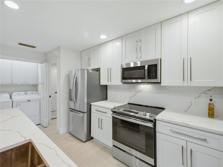 Nestled in a tucked away cul de sac in the heart of Palm Beach Gardens is this updated lakefront villa at Sun Terrace at the Oaks.  Remodeled kitchen with new cabinets, quartz counters and stainless steel appliances.  Updated primary bathroom.  Porcelain large format tile throughout.  Screened in patio with lake views for your enjoyment. Own a move in ready home in one of Palm Beach Gardens most desirable locations. Just minutes from top rated schools, beaches, shopping, dining and major highways. Schedule your showing today.