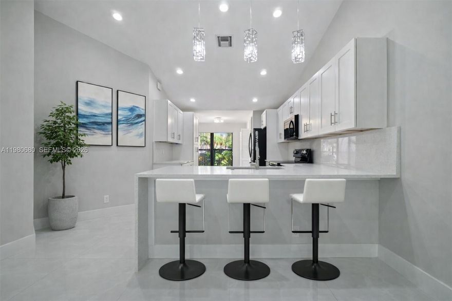 Discover redefined luxury in this fully remodeled 2-bedroom, 2-bath residence in the heart of Boca Raton. Every detail is crafted for comfort and sophistication: an open kitchen with an island, breakfast nook, stainless steel appliances, and gleaming porcelain tile floors. A bright sunroom opens to a screened patio, perfect for relaxing outdoors. The spacious primary suite features a large walk-in closet and a spa-inspired bath with a luxurious soaking tub, glass shower, and dual sinks. The home also includes a garage, ensuring convenience and security. Nestled in a gated community just minutes from beaches, upscale shopping, and fine dining, this is the epitome of a sophisticated lifestyle. Don’t miss this rare opportunity.