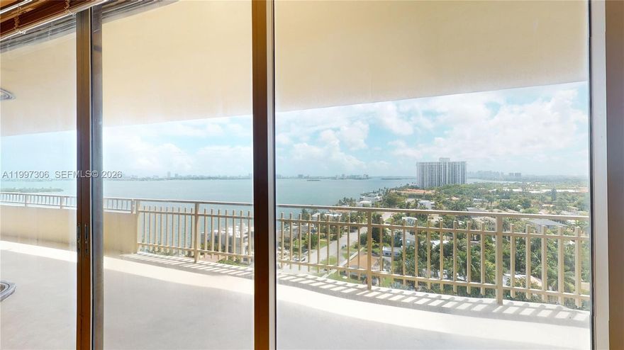Welcome to this highly sought-after corner residence at Jockey Club III, featuring exceptional space, natural light, and breathtaking waterfront views. This Two-bedroom, Two  full bathroom home plus a guest bathroom is ideally positioned in an exclusive bayfront building. Enjoy a spacious wraparound balcony with newly installed flooring—perfect for relaxing or entertaining while taking in panoramic views of Biscayne Bay. The residence features custom-built closets throughout and a versatile area ideal for a home office, studio, or den. The interior includes beautiful custom solid wood doors and a functional layout ready for your personal touch—an excellent opportunity to add value with a bit of TLC. A full-size washer and dryer are conveniently located in a dedicated laundry area with additional storage.
