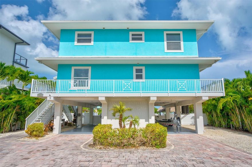 Welcome to Paradise Cove! The perfect vacation home and proven rental property. This fabulous waterfront home has beautiful ocean views, tropical pool and spa, tiki hut, & fully outfitted dock. Enjoy the large dock with a 14k lb boat lift, fish cleaning station, and ice machine. The first floor has a spacious living room, chef's dream kitchen, and a breezy balcony with views of the pool, canal, and ocean, 2 bathrooms and 2 bedrooms. Upstairs, the oversized master suite with sitting area, private balcony with ocean views & luxurious ensuite bathroom are your personal retreat. Additional large bedroom for guests with a private bathroom and a walk-in closet are on this floor as well as a large bonus/game room with a wetbar. MOTIVATED SELLER!!