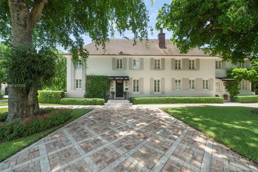 The epitome of elegance, this captivating French-styled 5,237 Sq Ft residence was restored by renowned architect Jorge L. Hernandez. The 4 bedroom 4.5 bath home features living areas that flow seamlessly to a light-filled family room with arched French doors which open to an outdoor paradise, with a gorgeous 100-year-old Ylang Ylang tree, patio, sparkling pool, and manicured landscaping. The professionally equipped kitchen with mystic white marble countertops has a large cooking island with seating. Take the elevator or 2 staircases to the second level, which includes the main suite with a walk-in closet and luxurious bath.  A winding iron staircase connects to the third-floor studio and attic. This impeccably designed home is on a corner lot with an additional entrance on Cellini St.