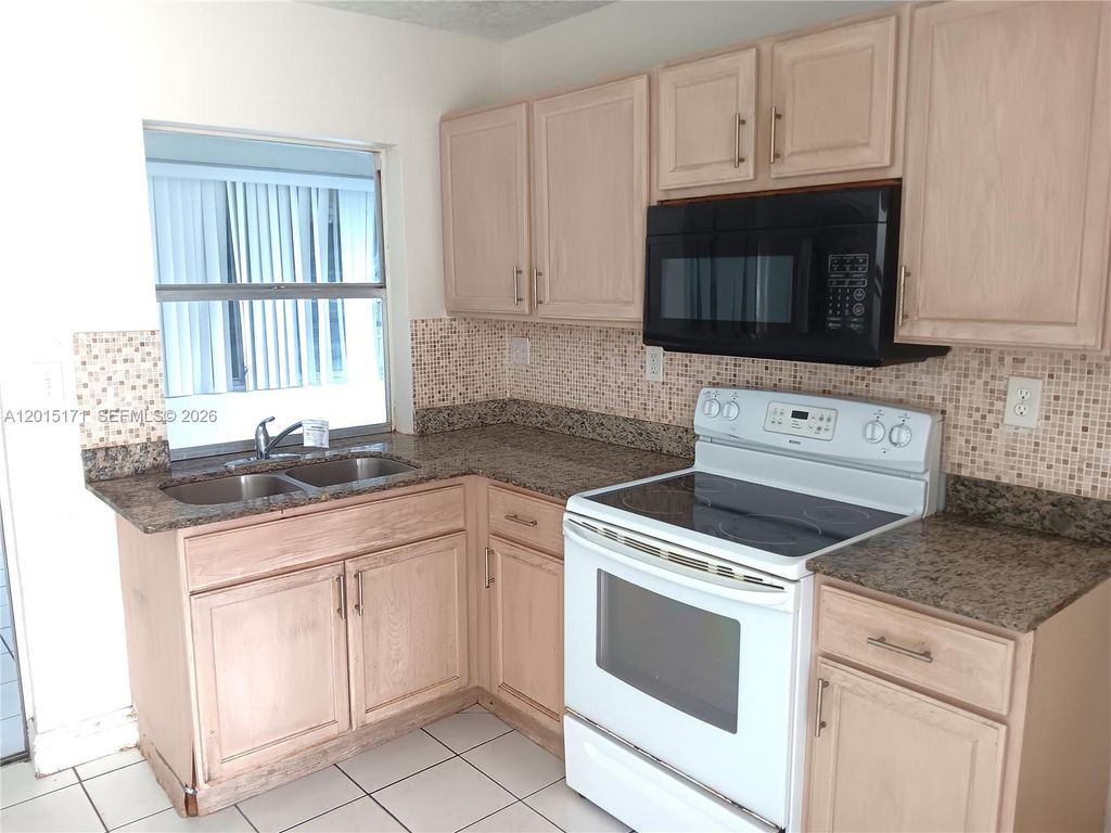 Photo of 7004 NW 67th Ave, Tamarac, FL 33321 (MLS # A12015171)