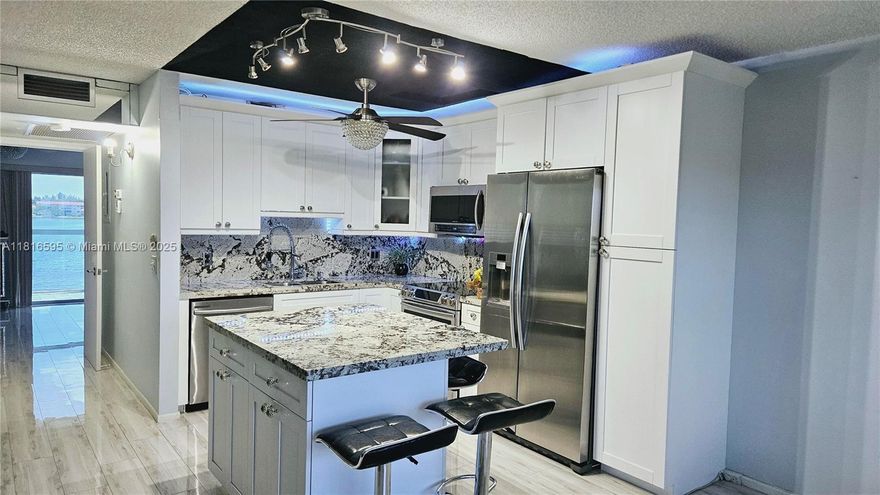 Currently Rented, Producing $2K Monthly Income. Exceptional Waterfront Living on Top 4th floor. Community Golf Access Avail. Complimentary Access to Resort Country Club Lifestyle 18k sq.ft clubhouse. Features include hurricane-impact tinted windows, 4 remote-controlled ceiling fans, LED decor timed lighting, a Complete remodel encompassing a new kitchen & bathrooms, an enclosed balcony, added second walk-in closet, roof attic storage, Newer AC system. Keyless main door entry, a luxurious spa shower panel, low-flow toilets, a bluetooth BathRm speaker/light fixture, tankless w. heater, whole-house water filtration, porcelain tile,HS internet, cable, gated, sec. patrol, free bus service, on-site nursing, ext.maint, roof insurance,water, garbage, movie theater 27pools 2gyms tennis/pickleball.