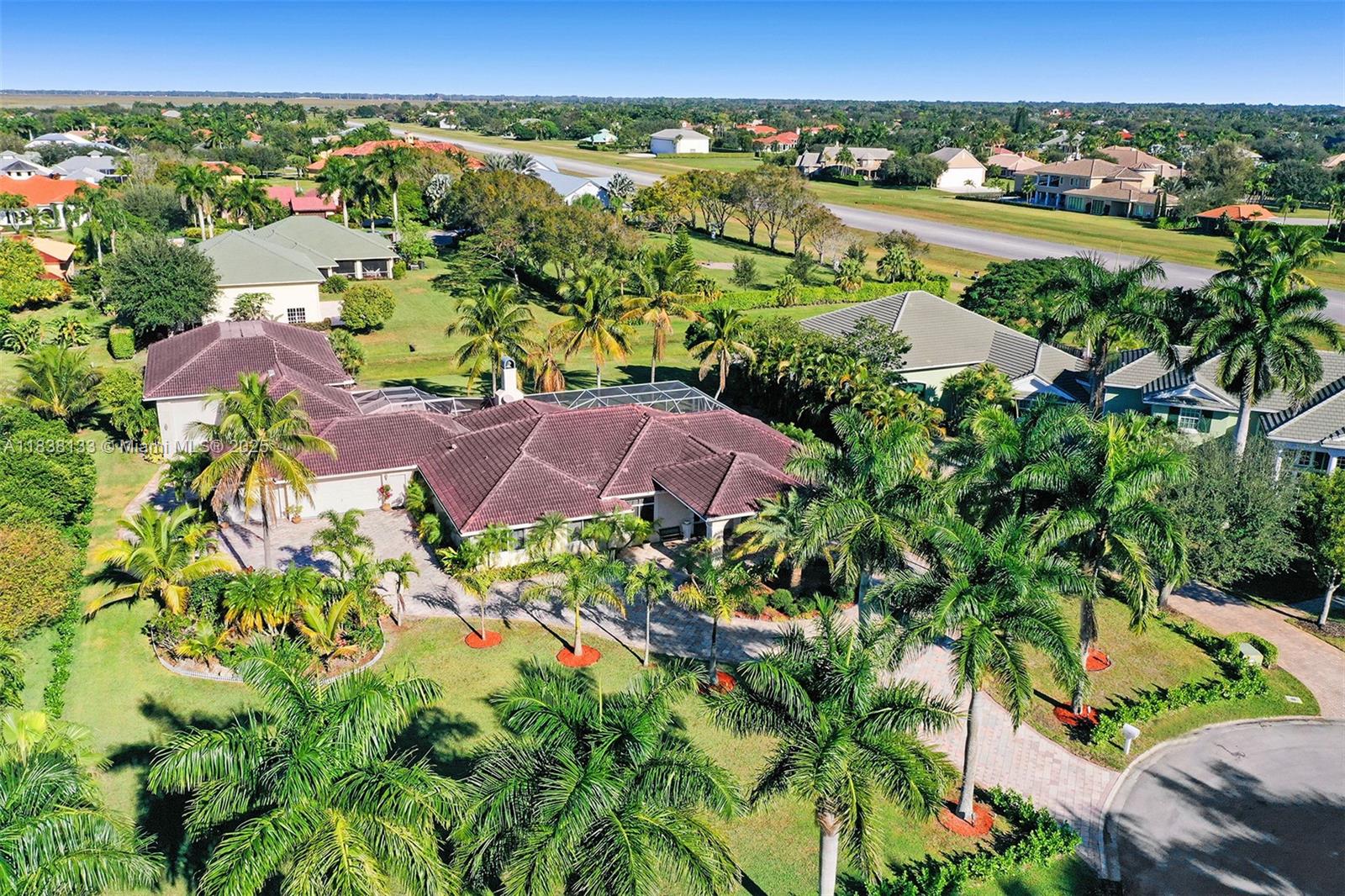 Have plane, fly home! Aeronautical Community in Wellington, FL. New roof completed in 2021 - custom-built well-maintained home with 50'W/40'L/14'C hangar. House built on foundation elevated out of the Flood Plain. Located on a quiet cul-de-sac, this gorgeous home is one lot away from the 4,000 ft paved & lighted runway with PAPI for quick taxi of jets/turboprops, & piston engine aircraft in all weather conditions. Max gross take-off weight of 12,500lbs. Fueling station - Jet-A / 100LL Avgas. Split floor plan 5 bed/4 bath, large open kitchen & living area, formal dining, Game Room next to oversized screened brick-paver patio with a 450 sq ft pool. Attached 4-car 852 sq ft garage w/impact doors w/8ft vertical clearances great for large SUVs. RV/Boat entry door with 14ft vertical clearance.