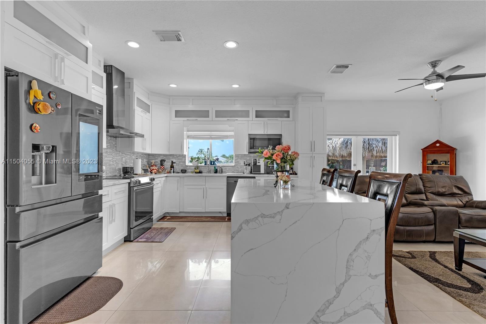 Welcome to Kayla's Place, a luxurious property with 5 bedrooms and 3 bathrooms. The first floor boasts large format porcelain tile floors. The kitchen has been beautifully renovated with new cabinets, a quartz cascade island, and quartz counters and backsplash. All new Samsung black stainless-steel appliances, including a touchtone refrigerator, are featured. Outside, the travertine marble pool deck and multi-color lights create a stunning outdoor space. A new tiki hut roof and pool shower complete the picture. Experience modern luxury at its finest at Kayla's Place.