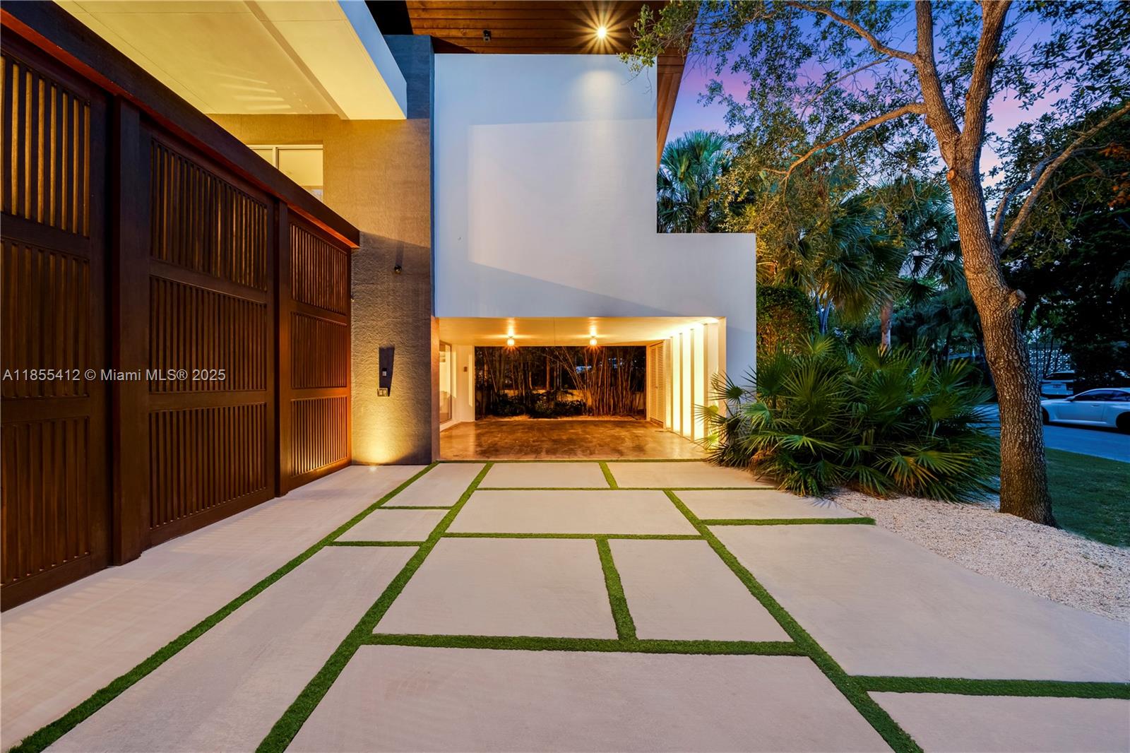 Key Biscayne – Architectural Masterpiece
On a secluded 9,633 sq.ft. lot near Harbor Drive, this 6,800 sq.ft. residence by Village Architects (Deborah de León) blends modern elegance with tropical serenity. A dramatic double wood door opens to a lap pool reminiscent of Amanpuri, framed by 2,000 sq.ft. of covered entertainment areas.
Inside, a glass-walled foyer, soaring ceilings, and a sculptural staircase set the tone. Formal dining, reception, and a chef’s kitchen flow seamlessly for refined living. The master suite offers vaulted ceilings, walk-in closets, a spa bath, and an adjacent office, complemented by three additional en-suite bedrooms.
Rare offering of design,privacy & resort-style living in the heart of Key Biscayne.Please view unbranded matterport t, floor plans & video.