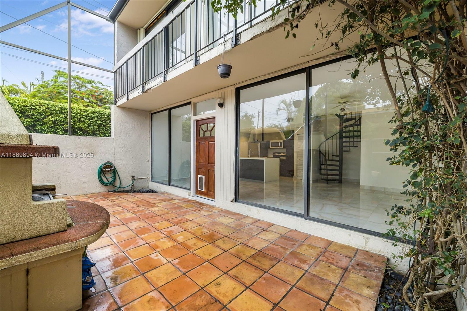 Renovated 2BD/1.5BA, 1,032sqft² corner townhouse in the heart of Coconut Grove. Bright 2-story layout with floor-to-ceiling glass doors that open to a screened patio—ideal for BBQs and seamless indoor-outdoor living. Updated kitchen with stainless steel appliances, in-unit washer/dryer, pet door, and a built-in clay oven (only unit with this feature). The main bedroom includes the only furnished item: a vintage dresser. Half bath on the entry level adds convenience. Gated community with pool and assigned parking. Located just steps from your parking spot for easy access to your perfect home. Walk to shops, parks, and CocoWalk. Large sliding glass doors fully open to merge indoor and outdoor living.