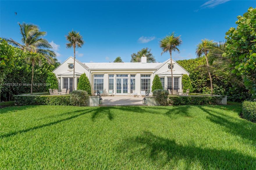 This impressive estate is located on North Beach Road on Jupiter Island, right on the ocean, with private beach access. The property is a beautiful Bermudian-style courtyard home with four separate buildings surrounding a tranquil pool and courtyard, offering a luxurious lifestyle. The main house boasts a grand primary suite with three walk-in closets, a spacious primary bathroom, a large living and dining room, a kitchen with a butler's pantry, a laundry room, a library, and an office. The guest house features three large bedrooms, three bathrooms, and ample closet space. The cabana includes a spacious open living room and kitchen, a laundry room, and a half bathroom.