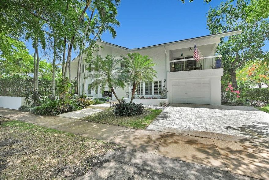 Located on a lush, tree-lined corner lot in Coral Gables, this beautifully updated mid-century modern home offers a perfect blend of timeless design and everyday comfort. A double-height entry and floating staircase set the tone for light filled interiors with warm wood floors, crown molding, and plantation shutters. The home features formal and casual living spaces ideal for entertaining. The upstairs suite includes a private balcony and a spa-inspired bath, while the additional bedrooms provide ample space for family, guests, or home offices. Portion of the garage has been converted into a fifth bedroom, perfect for use as maid or in-laws quarters. Just minutes from top-rated schools, parks, and the best of Downtown Coral Gables, this elegant residence offers style, space, and privacy.