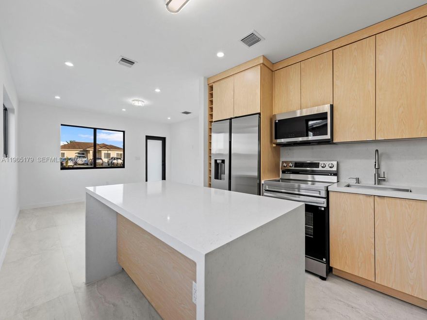 A true statement in modern living, this fully renovated residence has been masterfully redesigned with intention, precision, and uncompromising quality. Every detail has been elevated to deliver a refined, turn-key experience for the most discerning buyer.

The home unfolds with clean architectural lines, open-concept living spaces, and a seamless indoor flow designed for both everyday comfort and sophisticated entertaining. At the heart of the home, a custom chef’s kitchen commands attention, complete with premium appliances, bespoke cabinetry, and a striking waterfall-edge island that anchors the space with presence and style.

Major upgrades include a new roof, new A/C system, impact windows and doors, and beautifully installed modern flooring throughout, offering both peace of mind and timeless design. The primary suite is generously scaled, featuring a spacious spa-style bath with dual vanities and an elevated, private ambiance.
Outside, a large driveway provides convenience and flexibility. Positioned in a highly desirable, centrally located neighborhood near major highways, fine dining, shopping, and entertainment, this home offers effortless access to everything while maintaining a sense of privacy and prestige.

Completely finished. Exceptionally executed. Simply move in and live well.