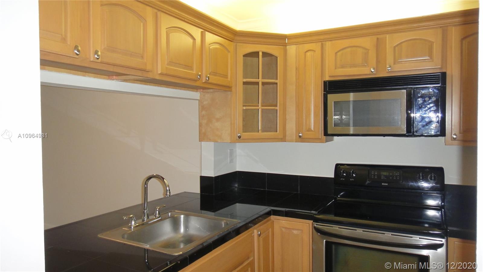 Look no further. Lovely and gorgeous upgraded 2/2 unit with wood cabinets in kitchen, granite countertops, SS appliances. Walking closet in master with en suite bathroom. Enjoy modern bathrooms recently updated; newer refrigerator, washer & dryer in unit, screened porch, tile and laminate wood floors, hurricane accordion shutters, crown molding; light and bright! Great location in the heart of Pembroke Pines. Call for an appointment.