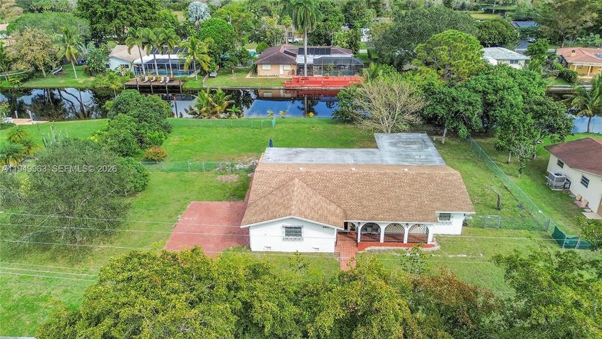 This charming waterfront home sits on an oversized lot – one of the largest in the serene neighborhood of Royal Palm Estates - offering ample space for family living and outdoor enjoyment. The lush property features fruit trees and room for RVs and boats, with space for future expansion. The home is within walking distance to top-rated schools (K-12) and conveniently close to a public golf course, nature preserve and large county park, while still being minutes from shopping. Relax by the canal with 150 ft of direct water access, perfect for boating. The expansive brick-paver patio and private pool provide the perfect setting for year-round entertaining. This ease of hosting continues out front with an oversized garage and a wide brick driveway for ample guest parking. The home’s open layout and tile floors invite sunlight to fill every room, creating a warm, bright atmosphere from the moment you enter. While perfectly move-in ready, it offers the rare chance to infuse the kitchen and baths with your own signature style. Call today to experience these unique features in person!