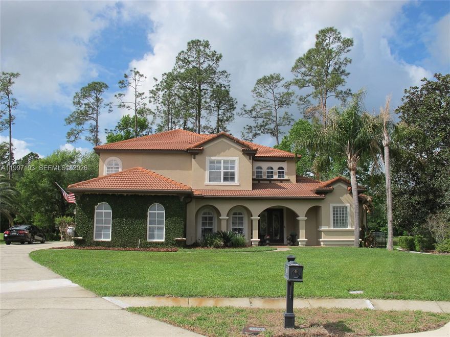 This stunning and well maintained 5 bedroom pool home nestled on nearly a half-acre cul-de-sac lot overlooks a lush forest and serene lake. Double glass front doors open to the formal living area with high tray ceilings and architectural designs. Enjoy the formal dining room complete with a white shiplap accent wall. The HUGE Family Room is big enough for the largest of families as well as a perfect entertaining space. A chef's kitchen is highlighted by double wall ovens, walk-in pantry, 42” cabinetry, ample granite countertops, and a lengthy raised eat-in counter. The breakfast nook overlooks gorgeous views of the lake and heated pool and spa (salt water setup installed). The screened in pool/patio includes a private half bath accessible only from the pool area. The 250 gal. propane tank for the pool heater means it’s outdoor fun all year long! The sophisticated Master Suite. It features a cozy retreat area with a beautiful view overlooking the gorgeous pool/patio & lake. LARGE CUSTOM WALK-IN CLOSET with built-in organizers create more storage. A LAVISH MASTER BATH features 2 separate His/Hers vanities and Hers with a Makeup Vanity! There is a Roman Tub enclosed by two Roman Pillars & a custom dual head shower. All the secondary bedrooms, along with an enormous loft, and porch are located upstairs to keep the busy lives of the family private. Other upgrades include: Plantation shutters and built-in speakers throughout and a 50 amp EV/RV charging port!