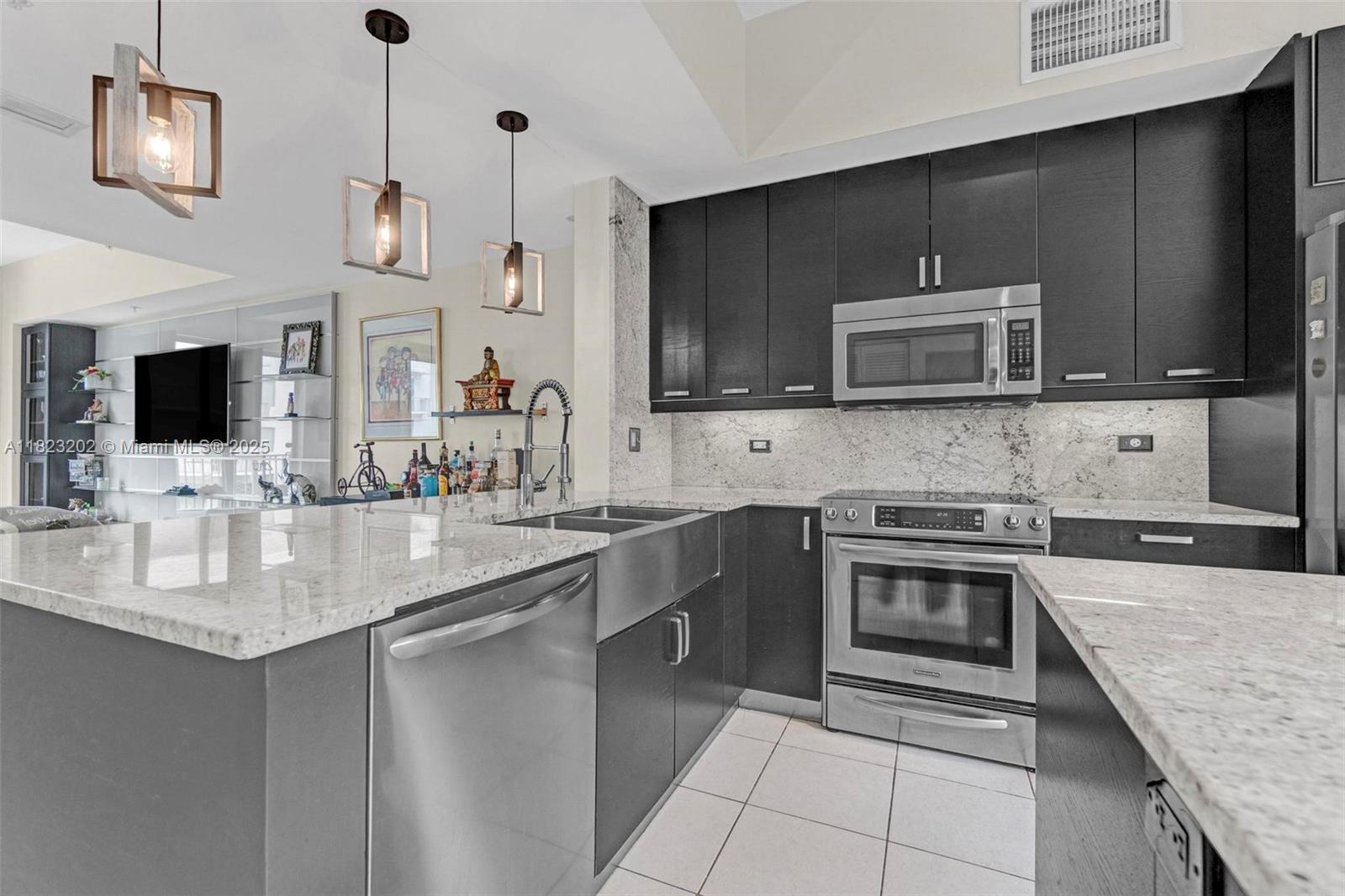 Live & entertain in sophisticated style! Fully renovated 4-bed, 3.5-bath townhome in the heart of Hollywood. Designed with high-end finishes & upgrades throughout, this OPEN-CONCEPT living features soaring ceilings, chef’s kitchen, oversized marble island, formal dining, breakfast bar & spacious balcony. Every window invites the outdoors in—sunlight, greenery, & serenity. Upstairs, 3 bedrooms are thoughtfully placed, with a luxurious primary suite, balcony, walk-in closets, whirlpool tub, dual vanities & separate shower. Lower level-French doors opening to private bed/full bath-plus direct access to 2 car garage. Walk to POOL, restaurants, shopping, with beaches, airport, Hard Rock Casino just minutes away. Stylish living in PRIME location! Furnishings available separately.