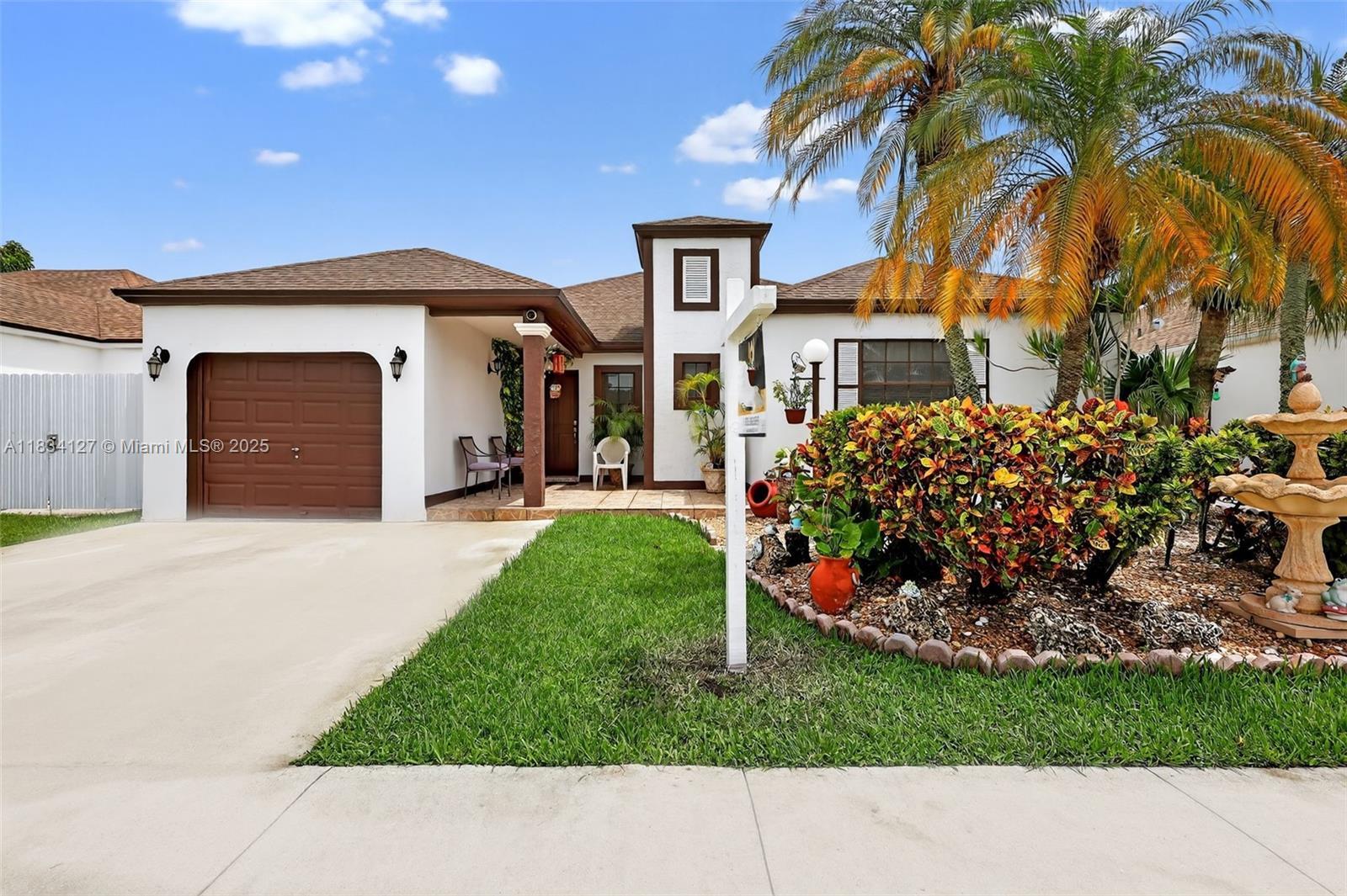NO HOA! Single-family home featuring vaulted ceilings and tile flooring throughout the main living areas. Bedrooms offer warm wood floors. Spacious laundry room with built-in shelving. The kitchen overlooks the dining area, ideal for everyday living and entertaining. The primary bedroom includes an en-suite bath with a walk-in shower. Enjoy the large, tiled, and covered screened patio—perfect for outdoor gatherings. Additional storage is provided by a backyard shed.