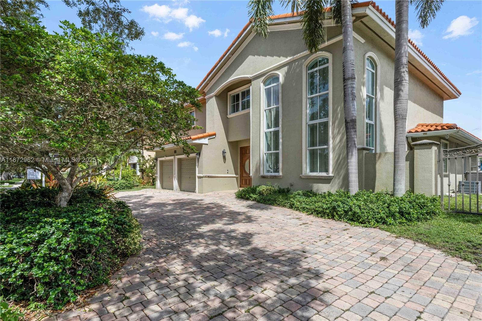 Nestled on a quiet, tree-lined street, this impressive two-story lakefront home built in 2002 offers 4 bedrooms and 5 full bathrooms with pool and impact windows - the perfect canvas for your dream residence. The convenient first-floor primary suite boasts two spacious walk-in closets and a luxurious spa-style bathroom. Upstairs features three additional en-suite bedrooms plus a versatile second-floor media/play room, providing ample space for family and guests. Additional highlights include elegant French doors opening to a covered patio, soaring high ceilings, whole house generator, two-car garage, and prestigious guard-gated Royal Oaks neighborhood in Miami Lakes.