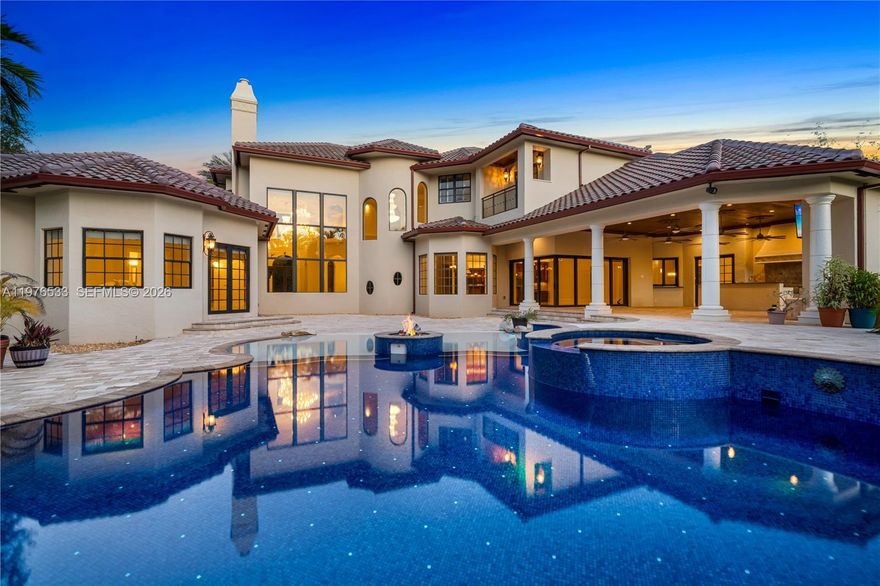 Perfectly located in the heart of Pinecrest along one of its most desirable corridors, this gated estate is tucked away on a lush acre-plus lot, offering privacy and convenience just minutes from top schools, parks, and the best of Miami living. Designed for comfort, entertaining, and effortless luxury, the residence features 7 bedrooms plus a private office, including a sumptuous primary suite on the ground floor overlooking the pool with soaring ceilings, designer lighting, and two oversized walk-in closets. The marble primary bath offers a soaking tub, an oversized shower ready for a steam system, and refined finishes.  At the center of the home, the chef’s kitchen is equipped with Thermador refrigeration, gas range, double ovens, hidden pantry, and breakfast nook. The kitchen flows into a spacious great room with fully retractable doors, seamlessly blending indoor and outdoor living. Entertainment spaces include a game room with full bar and cabana bath, temperature-controlled wine cellar, and multiple laundry areas.The home is fully wired for centralized audio/video control with LED lighting and Hunter Douglas blinds throughout, while a striking cylindrical elevator connects the levels. Car collectors will appreciate the three-car garage with lifts accommodating up to six vehicles. Outdoors, enjoy a heated saltwater pool finished in dark blue glass, propane fireplace, twilight landscape lighting, and expansive grounds. The property offers generous setbacks for privacy.