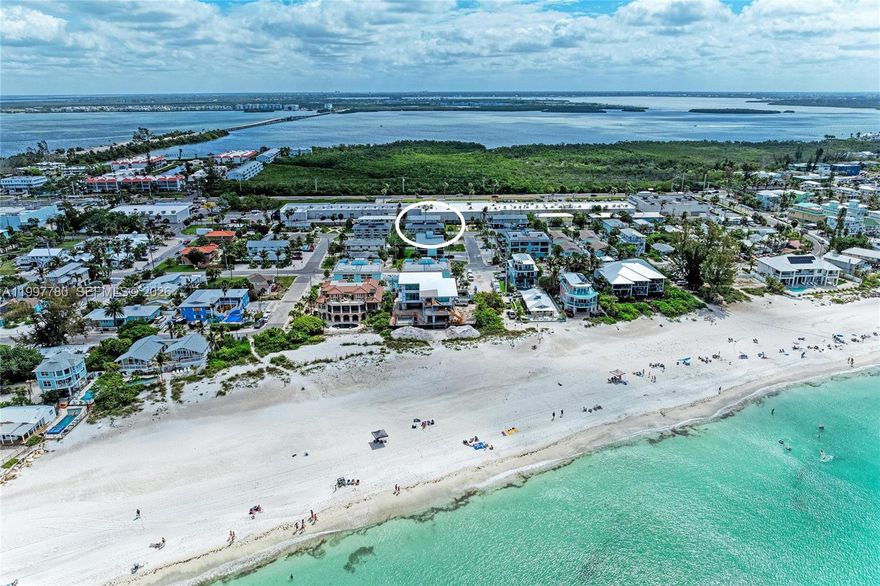 Turn-key furnished 2BD/2BA condo located directly across the street from the white sandy beaches of Anna Maria Island in Holmes Beach. This 900 sq ft unit offers a desirable two-level layout with living areas on the main level and bedrooms upstairs, each with its own private balcony. Open kitchen with island flows into a bright living space. Ceramic tile flooring throughout main areas. Community features a recently remodeled pool and fenced green area. Ideally located near restaurants, grocery stores, pharmacy, and shopping. Short-term rentals allowed, making this an excellent income-producing opportunity or perfect island getaway. Enjoy the charm of Anna Maria Island, known for its beautiful sunsets and relaxed coastal atmosphere, offering a wonderful setting to unwind and spend quality time by the beach.