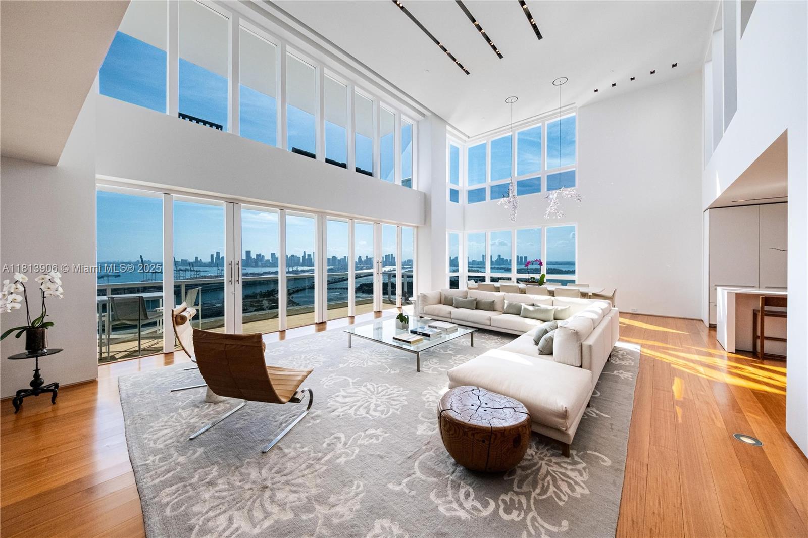 Another Collectible Property by the Jeff Miller Group! Penthouse A, the crown jewel of Murano Grande, is located in the heart of South of Fifth—Miami Beach’s most exclusive neighborhood. Spanning two floors and 5,305 SF, this architectural masterpiece was designed by Chad Oppenheim. Upon entry, you're welcomed by soaring 20-foot ceilings and sweeping sunrise-to-sunset views, of the Miami Skyline & Ocean. The Penthouse has been meticulously curated featuring a custom Boffi kitchen by Piero Lissoni, Burmese teak flooring, matching sandstone terraces, and a floating staircase. Additional highlights include Holly Hunt materials, Crestron Smart Home, a Swarovski crystal chandelier, Kreon lighting, Poliform closets, and spa-quality bathrooms with Boffi cabinetry and Dornbracht fixtures.