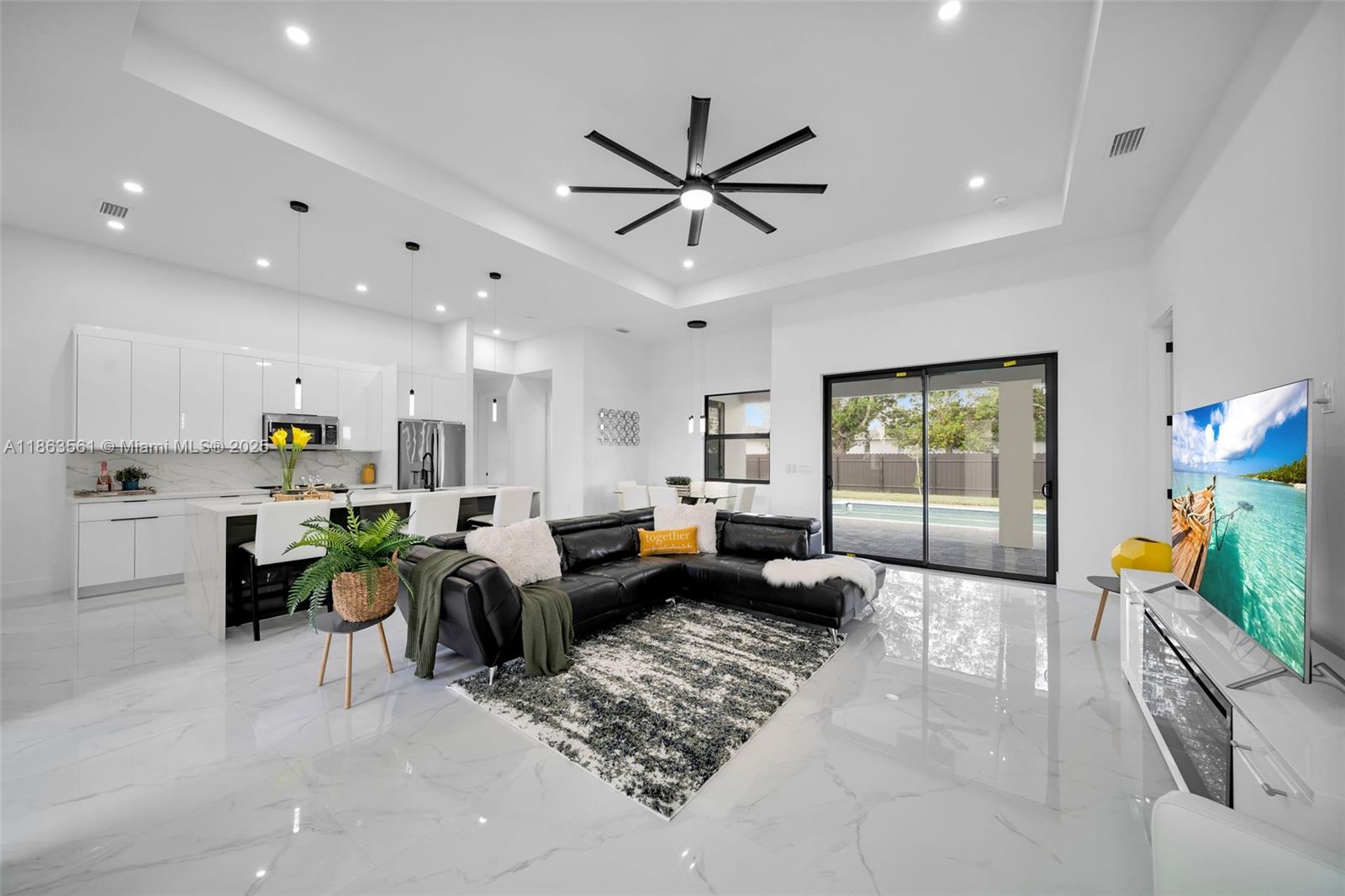 Experience modern Florida living in this 2024 new construction 4-bedroom, 2-bath home. The primary suite features dual walk-in closets and a tiled stand-up shower, while the second bath has backyard access. Enjoy a private saltwater pool with new heater, all furniture included for a turnkey experience. Porcelain tile flooring flows throughout, complemented by a 2-car garage, 4-car driveway, and storm-impact windows and doors. The chef’s kitchen boasts a Calacatta Quartz waterfall island, high-end appliances, and pop-up wireless charging. LED lighting, ceiling fans, and a dramatic living room fan enhance comfort. Step onto the lanai with a fully equipped outdoor Florida kitchen and lush landscaping with sprinkler system—luxury, style, and function all in one.