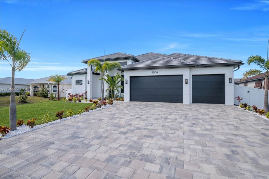 Experience the pinnacle of modern luxury in the beautiful city of Cape Coral, Florida. This exquisite 3-bedroom, 3.5-bath estate showcases dramatic soaring ceilings, refined architectural details, and impeccable craftsmanship throughout. Designed to impress, the open-concept living space flows seamlessly into a designer kitchen appointed with top-of-the-line stainless steel appliances, custom cabinetry, and elegant European tile flooring. A private executive office offers the perfect work-from-home retreat. Each bedroom is a true sanctuary featuring custom built-in closets and expansive walk-in closets, while the spa-inspired bathrooms boast floor-to-ceiling designer tile, dual rain shower heads, and luxury finishes worthy of a five-star resort. Step into your own private paradise outdoors—an entertainer’s dream complete with a resort-style pool, fully equipped summer kitchen, and an oversized covered lanai ideal for hosting or relaxing in total privacy. The home is completed by a three-car garage with European tile and an array of top-of-the-line upgrades throughout, delivering a lifestyle of sophistication, comfort, and elegance. This is more than a home—it’s a statement of luxury living.