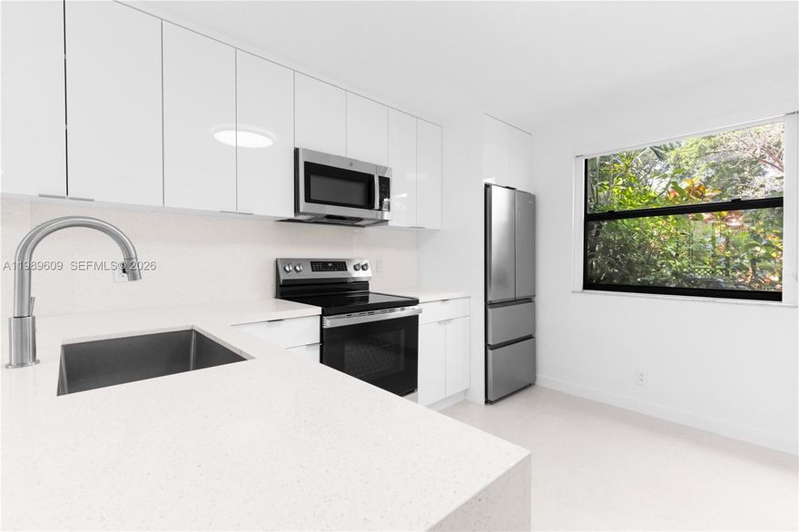 Completely renovated 2BD/2BA first-floor condo at Grand Marquis Condominium in Plantation — brand new for a qualified tenant. Every finish, fixture, and appliance is new; you'll be the first to enjoy it all. Open living and dining area with sliding glass doors to a private patio overlooking a serene lake. Stunning kitchen with floor-to-ceiling high-gloss white cabinetry, quartz countertops, and all-new stainless steel appliances including French door refrigerator, glass-top range, built-in microwave, and dishwasher. Both bathrooms fully redesigned featuring frame-less glass showers, large-format porcelain tile, pebble mosaic floor, rain shower-heads, floating vanity, and backlit LED mirror. All closets are custom built-in with dedicated hanging space, shelving, and drawers — no extra furniture needed. In-unit stacked washer/dryer, smart thermostat, updated LED lighting, and polished tile floors throughout. Hurricane impact doors and windows throughout. 963 sq ft. Unit comes with 2 assigned parking spaces. Enjoy top-tier amenities: pool, tennis court, BBQ area, gym, party room, and lush green spaces—all in a gated community. Prime location near Sawgrass Mall, dining, and shops. Pet-friendly (under 30 lbs). Move-in ready. Won't last — schedule your showing today.