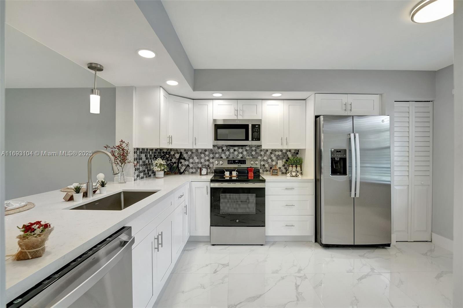 FULLY REMODELED 2beds/2baths, Popular J MODEL:1,192 sq.ft. in Buckigham N-206, Century Village This unit counts with BRAND NEW EVERYTHING: WASHER/DRYER, WATER HEATER, NEST THERMOSTAT, CENTRAL AC less than 2 years old & ELEVATOR in building.MODERN OPEN KITCHEN w/NEW GE S.S. APPLIANCES, QUARTZ countertop. RANGE GLASS TOP has AIR FRYER & CONVECTION OVEN. NO POPCORN.NEW PORCELAIN FLOORS THROUGHOUT. NEW TOILETS, NEW VANITIES w/ LIT MODERN DIMMABLE LIGHTED MIRRORS. LARGE WALK-IN CLOSET in main bedroom & NEW WALK-IN SHOWER w/glass doors. NEW tile flooring & screens IN BALCONY. NEW snow white BLINDS on every window! HOA Includes water, trash & sewer, basic cable, internet and endless amenities: a million-dollar resort style club house w/gym, tennis courts, pools, golf course, community bus & more