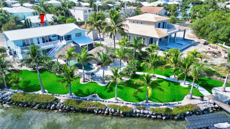 Seller Financing Possible!!! Tropical Oasis with Spectacular Open Water Views!!!! World Famous Sombrero Beach- This Newly remodeled 2/2 up & 2/2 down. Completely New Beautifully Landscaped Tropical Yard with Artificial grass - Custom Pool covered with 2 inviting Tiki Huts, and Dual Boat Lifts -10,000 & New 24,000.  This oversized Lot provides ample space for all your toys, and the in-law suite adds flexibility for guests or extended family. Impact windows and doors, a metal roof, and an elevated position above flood level. This home features abundant storage space with a Carport and pool storage, room to meet all your needs. Quick access to the Ocean and Bay.