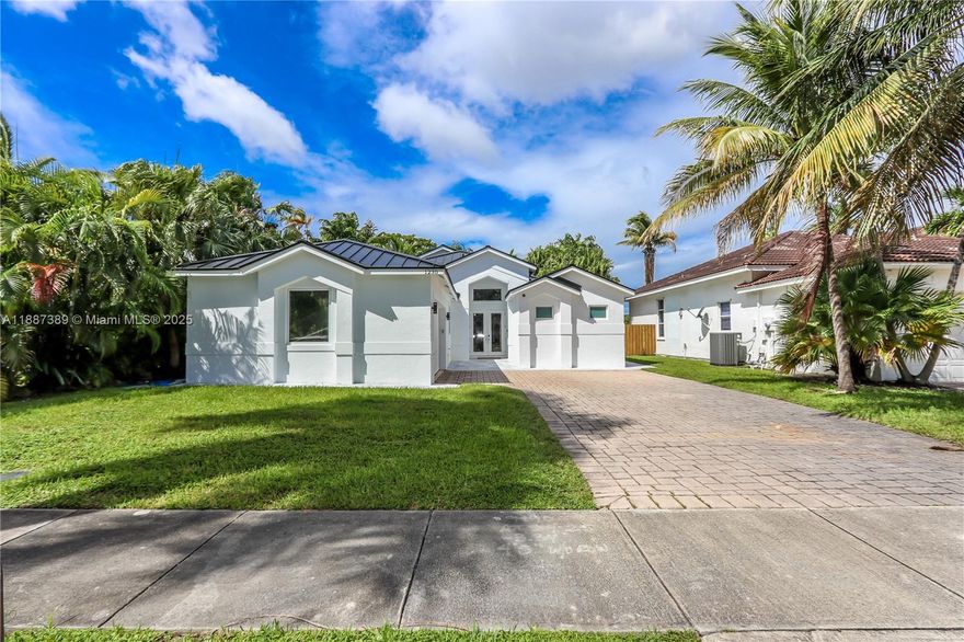 This beautifully crafted 3 bed, 2.5 bath home with pool and additional den/office sits on a quiet cul-de-sac just minutes from Hollywood Beach! Vaulted ceilings, marble floors, and expansive windows create a bright and airy atmosphere, while the open kitchen shines with quartz countertops and stainless steel appliances. The split floor plan offers privacy with a versatile den for office or guest use. The primary suite is a luxurious retreat with a sitting area, spa-like bath featuring a roman tub and walk-in shower, and custom closets. A fenced backyard with pool and patio is perfect for entertaining or unwinding. Freshly painted inside and out, complete with a new roof, two-car garage, and ample parking, this move-in ready residence combines comfort with timeless elegance.