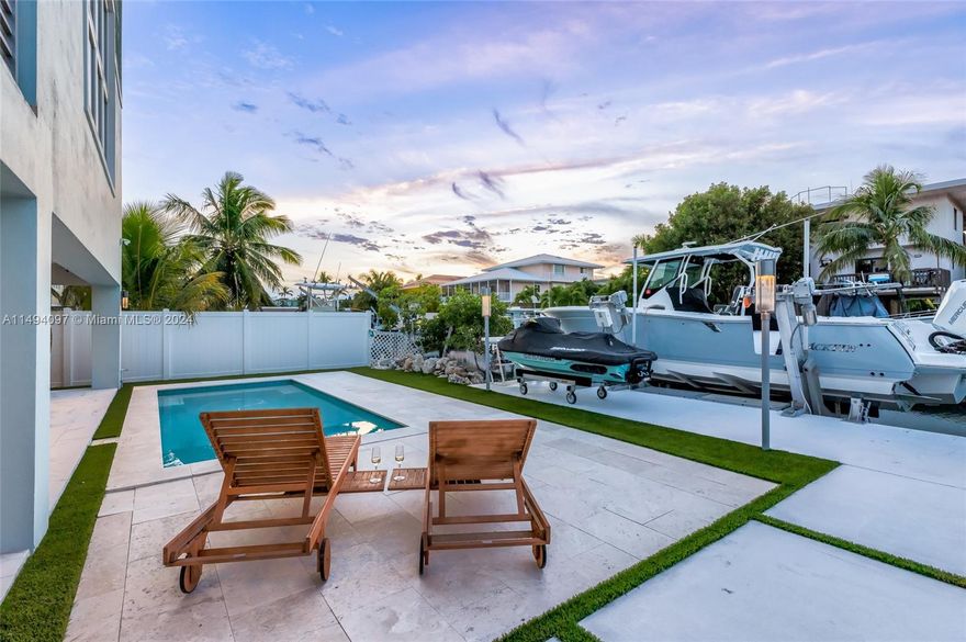 Luxury Canal Front Custom Home nestled in the prestigious Plantation Key Colony. Meticulously crafted in 2018, this residence showcases an exquisite blend of professional design and impeccable decor, embodying the epitome of luxury living. Boasting five spacious bedrooms and 4.5 bathrooms. Open concept living and entertainment area, adorned with 20-foot volume ceilings. The loft, gracefully overlooks the living area.  A concrete dock and boat lift await, providing effortless access to the stunning Florida Bay and the vast Atlantic Ocean. Indulge in the convenience of a beautiful concrete pool. An outdoor kitchen equipped with everything you need. Double car garage. Embrace the beauty of this coastal paradise.