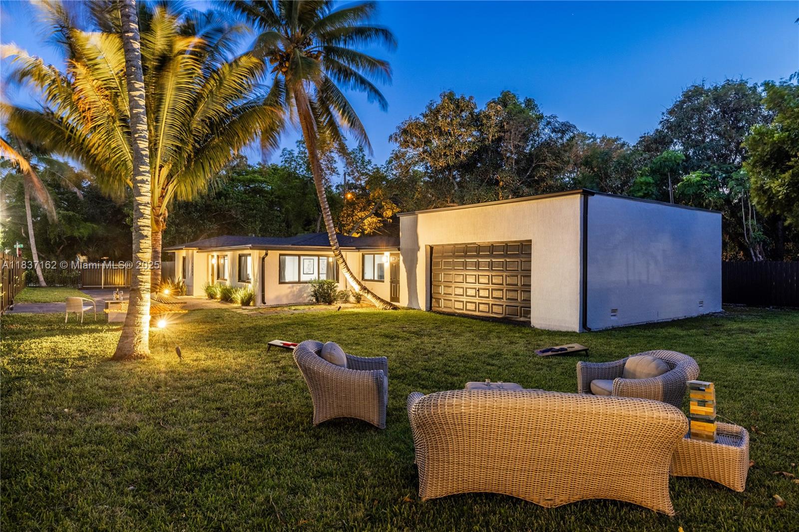 Welcome to Palm Ranch Miami! Live large in this nicely-updated modern private gated creative compound on a huge quarter of an acre lot. Convenient open-flow plan with multiple living areas, dining spaces, and a custom designer eat-in island kitchen with walk-in pantry. So much space, with a split four bedroom plan, including the main suite retreat and dreamy guest rooms. Outside, enjoy fab lush tropical landscaping with great space to entertain and relax, even room for a pool. Plus, there's an attached ~600 SF enclosed flex space, great as a studio, office, gym, workshop, or garage... how cool! Recently updated with new impact windows, roof, designer kitchen baths, flooring and fixtures all at a fantastic price in a convenient location. You'll agree, this is a MUST SEE property!