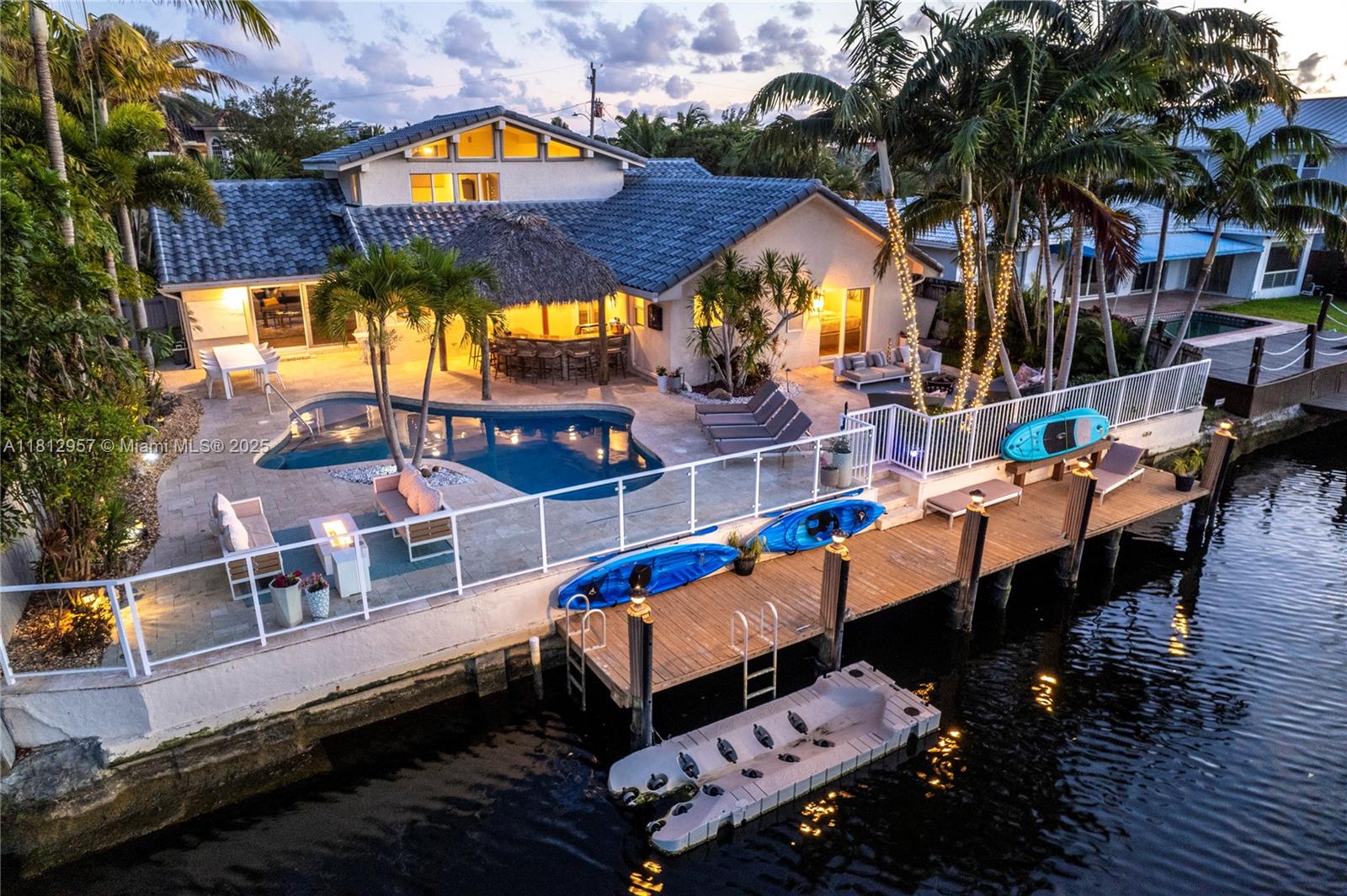 Seasonal rental - Waterfront home in gated Bal Harbour offers 75' of ocean-access frontage and incredible views of the Middle River. Featuring 6 beds, 4.5 baths, home features impact windows and doors, vaulted beamed ceilings, and an open kitchen with adjacent dining area. The living room includes a gas fireplace and open stairway to the second floor. Enjoy updated baths, and an en suite primary bedroom located on the second floor. Outdoor features include a full gas BBQ, freeform heated pool, and full-width dock—perfect for entertaining. Prime location near Galleria Mall, top dining, shopping, and just minutes to the beach and downtown Fort Lauderdale.