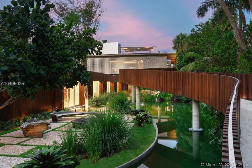 Raising the bar for ultimate luxury, this 15,000 sf ultra-modern home with a palette of exposed concrete, stone & teak wood all set within Raymond Jungles landscaping highlights the meticulous attention to detail throughout. Designed by world-renowned architect Marcio Kogan, built by Brodson Construction, this residence is a masterful achievement of concept & design. Among its unrivaled features is a 200 ft bridge overlooking a man-made lagoon, clean linear pool, 1,800 sf terrace, 2,250 sf gym/official NBA indoor half court. Pocket doors in the second floor living space & ground floor master bedroom blur the lines between the indoors/outdoors capturing stunning ocean & water views. Offering 6 BR,7+2BA on approx. 1 acre with 100 ft on the most coveted waterfront location on Pine Tree Dr