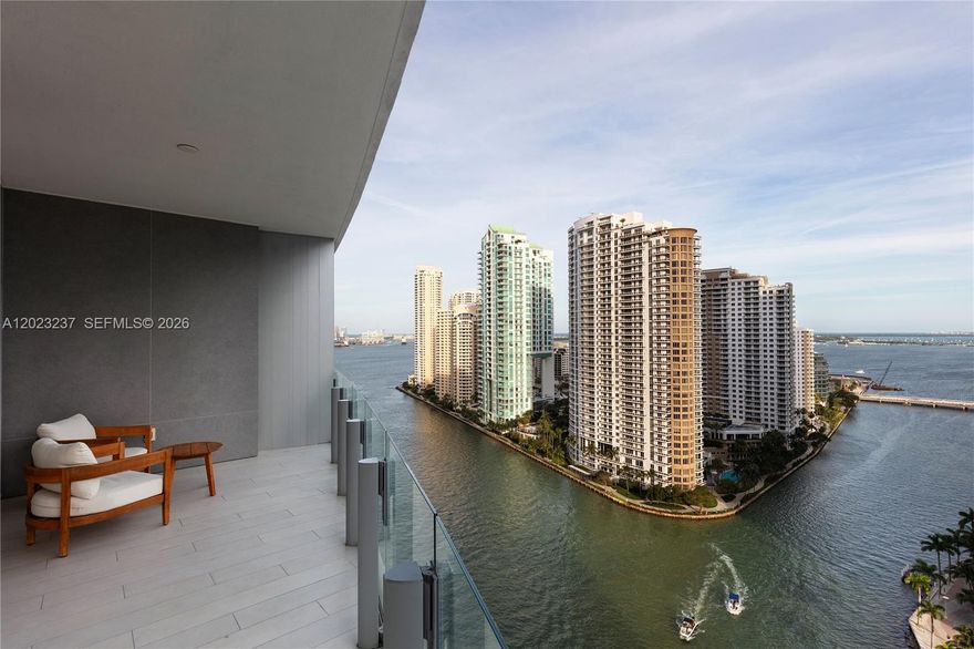 Waterfront Living at Aston Martin Residences
Set within Aston Martin Residences, Unit #2107 is a refined Downtown Miami waterfront offering defined by private arrival, sculptural architecture, and a crescent-shaped floor plan that follows the building’s curved glass façade. Located on level 21 within the Panoramic Residences collection, the 3 bedroom, 3 full and 1 half bathroom home offers a total of 2,619 SF+/- living space, including 2,462 SF+/- of interior space and 157 SF+/- of exterior space. A private elevator opens to a dedicated lobby, establishing a discreet arrival experience before the plan unfolds toward open living spaces, floor-to-ceiling glass, and layered views of Biscayne Bay, the Miami River, Brickell Key, and the Downtown Miami skyline.
Unit #2107 brings together the architectural identity of Aston Martin Residences with a thoughtful 3-bedroom layout, private elevator access, a dedicated lobby, a waterfront terrace, 2 parking spaces, and a crescent-shaped plan that maximizes light, flow, and views. The result is a complete Downtown Miami offering shaped by privacy, service, and the rare experience of living within one of the city’s most recognizable waterfront towers.