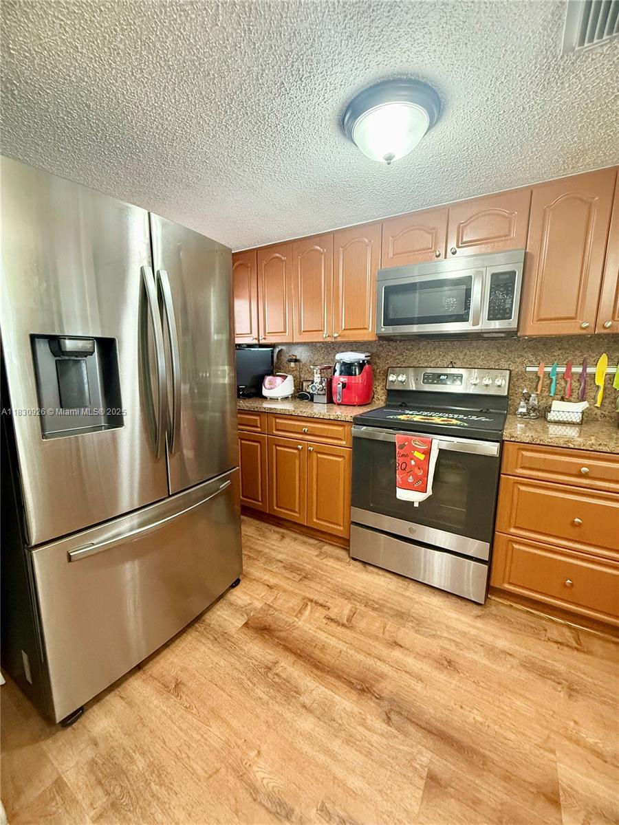 Welcome to your serene oasis! This spacious corner unit with breathtaking lake views is perfect for those seeking comfort and style. Step inside to discover brand-new wood floors throughout. Enjoy the convenience of impact windows & a new water heater. Featuring 3 generous bedrooms & 2 bathrooms, this condo offers ample space for relaxation and entertainment. The in-unit washer & dryer add to your convenience, while the building provides excellent amenities including elevators, laundry facility & a refreshing pool. Safety is a priority with outdoor cameras for added security. With a roof that's only 2 years old, you can move in with confidence! Building has been recently painted & remodeled of the common areas. Plenty of parking spaces. Don't miss this opportunity to own this great unit.