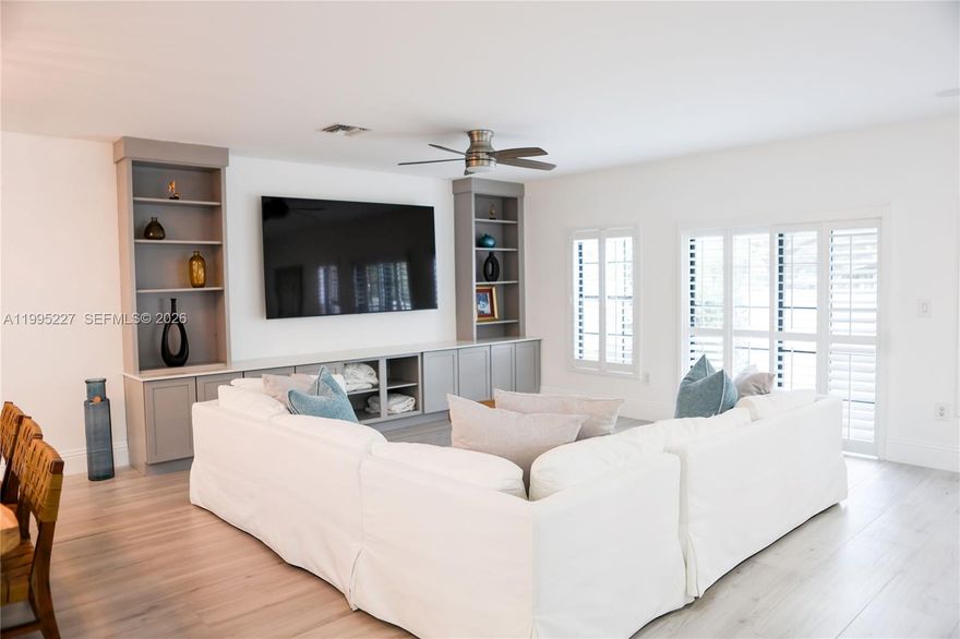 Discover luxury living in this massive 3-bedroom, 2.5-bath corner unit with an expansive open floor plan, park views, and a large patio—perfect for entertaining. As a unique corner unit, it offers exceptional privacy and natural light.

The custom kitchen features WiFi smart appliances and elegant marble countertops. The living room boasts a built-in entertainment center with surround sound speakers, while a dramatic floating stairway leads upstairs.

All three bedrooms enjoy private balconies. The master suite is a true retreat with a spa-like bath featuring a rain shower, marble finishes throughout, and spacious California walk-in closets. Additional baths are modern and updated.

Premium touches include high-impact windows and doors, a tankless hot water heater, and a 2-car garage with epoxy floors.

Boaters will love the rare 35-foot deeded dock just steps from the home, complete with a boat lift (up to 30,000 lbs) and direct ocean access. Power and water at the marina dock are included!

The association fee covers the roof, insurance, cable, internet, and dock utilities—truly worry-free living.

This rare gem won’t last long. Schedule your private showing today!