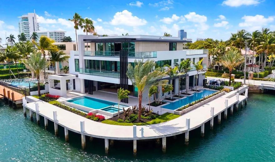 Set on a coveted point lot within the exclusive Harbor Beach enclave, this newly constructed modern estate represents a premium tier of waterfront luxury. Positioned on a rare East Point, the property offers 250 feet of deep-water dockage for large yachts or multiple vessels, with commanding views across Lake Sylvia to the downtown Fort Lauderdale skyline. Expansive water views are experienced from all levels, while the grounds unfold as a private resort setting with multiple pools and outdoor living spaces.
Spanning three levels, the residence features exquisite Italian finishes, walls of glass, and a seamless indoor-outdoor flow. The home includes seven bedrooms, a wellness center and gym, an executive office, and a primary suite positioned to capture sweeping water views, with a spacious his and her bathrooms oriented to the waterfront.
Designed for both entertaining and everyday living, the estate offers a one-of-a-kind third floor with media room, game room, wraparound terrace, rooftop lounge with a custom bar and panoramic views across the water and skyline.
The outdoor setting is a resort-style retreat with multiple pools, a hot and cold plunge, sauna, and steam showers, along with a summer kitchen, bar, dining areas, waterfalls, and fire features. Located within gated Harbor Beach, residents enjoy close proximity to the beach, marina, private surf club, Las Olas, and Fort Lauderdale’s premier dining and coastal lifestyle.