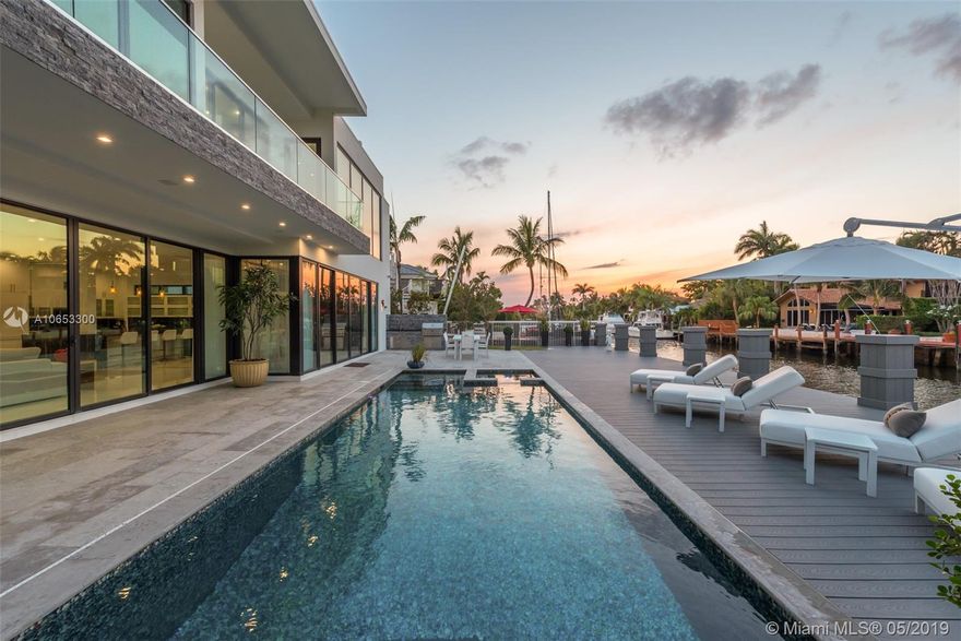 Contemporary, waterfront masterpiece located in Fort Lauderdale's most sought after location, SEVEN ISLES.  Indoor & outdoor living blend perfectly  with over 6800 sq feet of open flow thru space that leads out to the pool, jacuzzi, outdoor kitchen, & 76 ft dock/ direct ocean access. Beautiful views from the open concept gourmet gas kitchen, dining and living area with dedicated wine cellar. ROOF TOP open space with 360 degree views. Steps away from Ft Lauderdale Beaches & restaurants   Easy drive to 2 international airports
