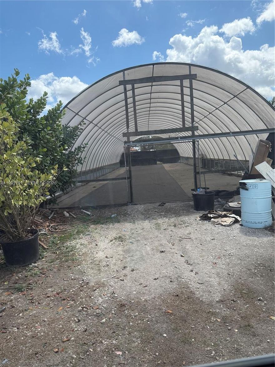 Great Area located in the Redlands Agricultural district, few blocks from Krome-excellent area.  For rent ONLY one large green house ready with electricity, irrigation/water, above ground planters ideal for Hydroponic vegetable/plant growing. Monthly rent $1,700.00. Located in a 5 acre agricultural land, fully fenced/ security system. Call for further information.