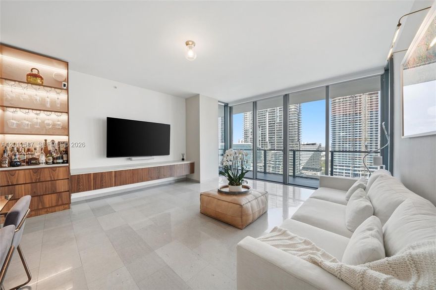 Sophistication meets modern luxury in this stunning 3-bedroom, 3.5-bath + Den residence located on the 19th floor of REACH, the iconic tower at Brickell City Center. Spanning 1,641 square feet, this home is designed to impress with its soaring ceilings, open-concept living and dining areas, and a versatile den. Step out onto your private balcony to soak in breathtaking views of the river and city skyline—perfect for unwinding or entertaining. Each bedroom boasts its own en-suite bath, while custom-designed built-ins add both style and functionality throughout.

Residents enjoy unparalleled amenities, including a resort-style pool, hot tub, state-of-the-art fitness center, yoga studio, business center, billiards room, and the convenience of a 24-hour doorman, concierge, and valet service. All this, just steps from Brickell’s premier shopping, dining, and entertainment. This is more than a home—it's a lifestyle. Welcome to the heart of it all.