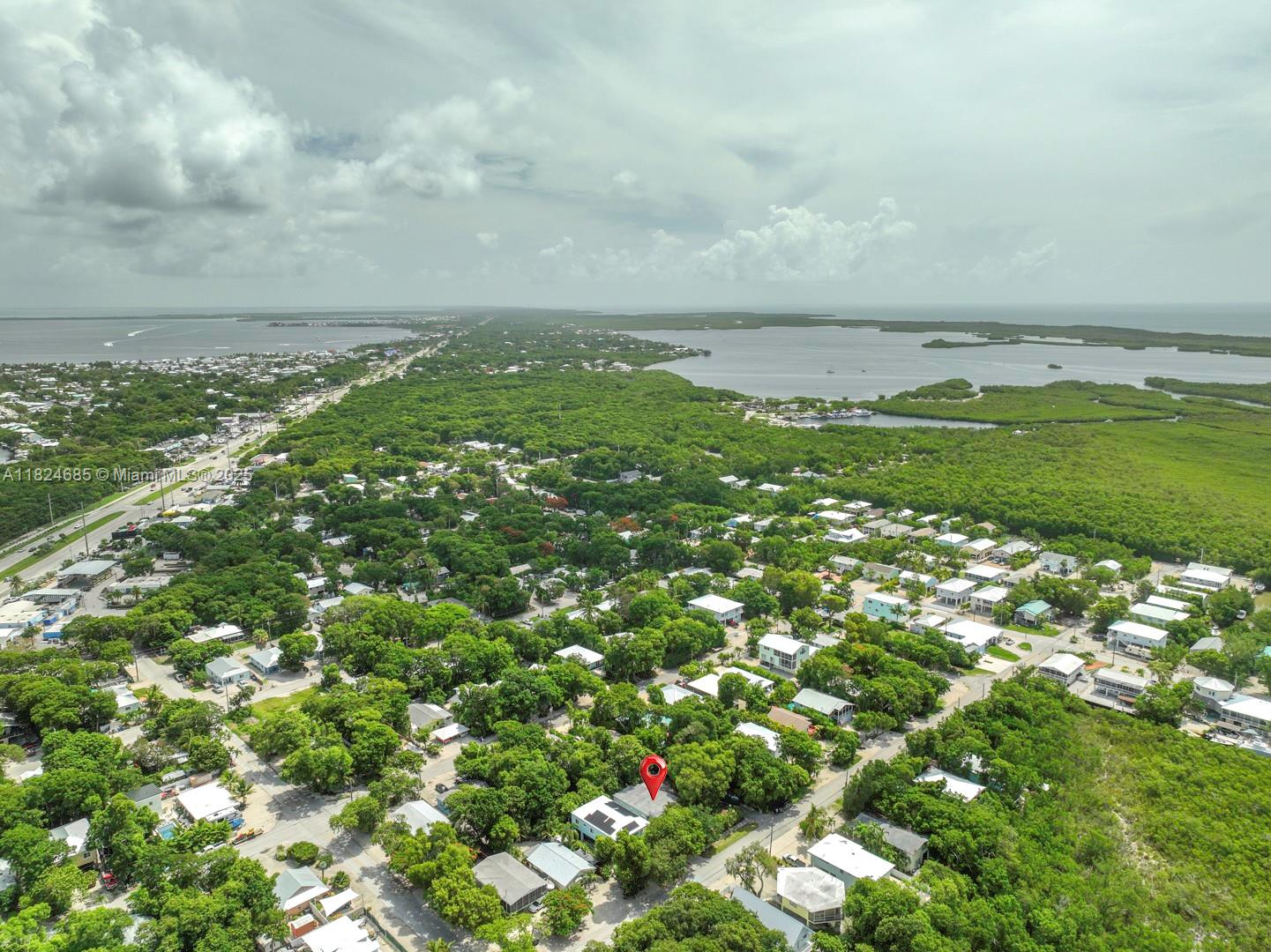 Tropical Oasis in the heart of Key Largo, located on Mile Marker 102.5 (ocean side). This charming 2/2.5 CBS home sits on a buildable double lot (10,700 sq ft. rarely available). Features include updated interior with modern upgrades, tile floors throughout, impact windows, and large screened patio surrounded by lush tropical landscaping. The oversized lot has plenty of space for your boat, RV, water toys, even adding a pool or expanding the home. The property is located minutes from John Pennekamp and marinas. Enjoy boat ready access from multiple launch points to both the Ocean and the Bay, making it effortless to enjoy boating, kayaking, paddle boarding, or jet skiing. Book your private tour now before it’s gone!
