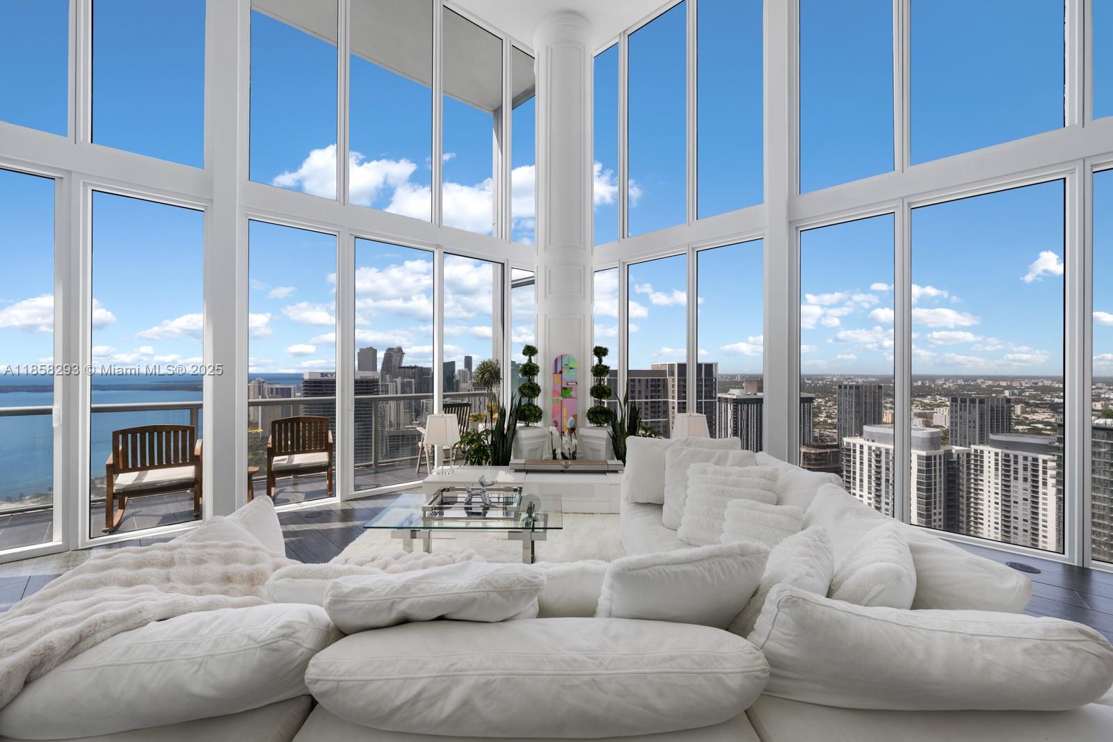 Newly renovated corner duplex penthouse with infinity views of Miami Beach, Biscayne Bay, Brickell & Westward. Dramatic 22’ glass walls and multiple balconies capture a 300° panorama of sunrises, sunsets, and iconic landmarks—an intricately active, living postcard. Interiors showcase porcelain floors, alabaster sconces, custom wainscoting, and Versace marble spa baths with smart toilets, infrared light therapy, privacy glass, and WaterWorks dual station steam shower system. Chef’s kitchen with Sub-Zero/Wolf, Devialet sound, automated blackout blinds, hidden cinematic screen, sliding mirror shoe salon, concealed storage cove, one-of-a-kind chandelier, and customizable LED lighting throughout—a masterful balance of Classic and Modern aesthetic, unmatched in luxury, innovation, and design.