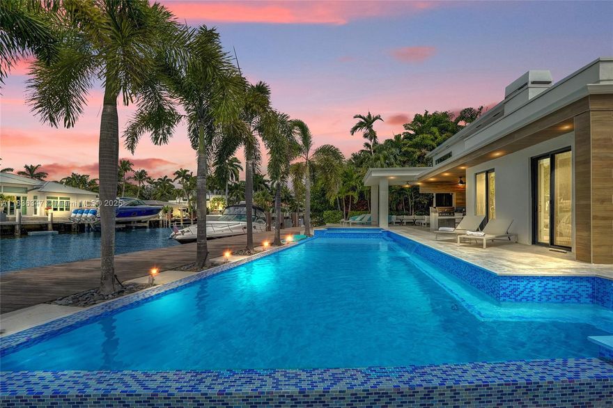 Luxury Waterfront Living on Aqua Vista Blvd in the Seven Isles neighborhood off Las Olas Blvd. This estate offers 100 ft of deep-water frontage with direct ocean and intracoastal access, perfect for large vessels. Controlled access at the community entrance and a gated driveway ensure privacy and peace of mind. Soaring vaulted ceilings in the living room add 1,000 extra square feet, creating an open, spacious atmosphere filled with natural light. Updated flooring, 4 en-suite bedrooms, 5 full baths, and a versatile den. Move-in ready with a new roof and 3 new AC units. The west-facing backyard features full sun, a refinished pool, travertine marble patios, and breathtaking sunset views. Don’t miss this rare opportunity to embrace the ultimate Fort Lauderdale waterfront lifestyle.