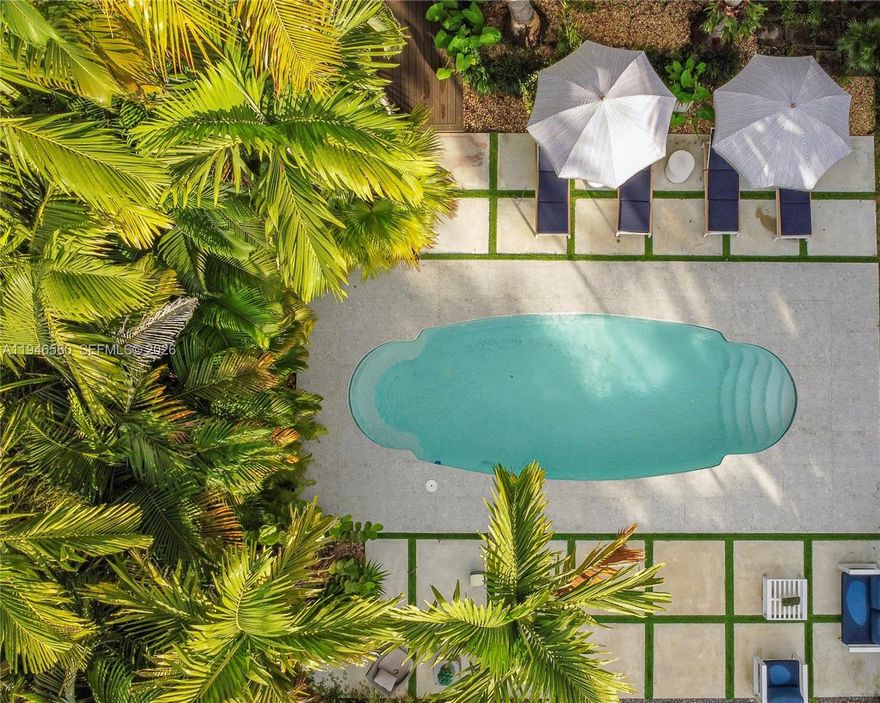 Rare opportunity in desirable Biscayne Park with fully approved and paid expansion permits in place. This beautifully updated, move-in ready home offers 3 bedrooms, 2 baths, and 1,540 SF on a generous 0.26-acre lot. Bright open living spaces, impact windows, and classic marble, terrazzo, and tile flooring create timeless appeal. The private backyard features mature landscaping and a pool ideal for entertaining. A separate living area with kitchenette and bath provides flexible use for guests, in-laws, or home office. Approved plans expand the home to 2,799 SF, adding a luxurious primary suite, spa bath, walk-in closets, laundry room, cabana bath, and covered veranda—allowing buyers to bypass permitting delays and build significant long-term value.