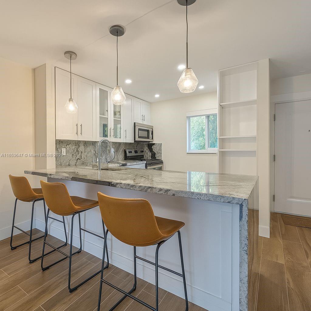 Completely updated 2-bedroom condo with modern tile throughout, a new kitchen, open-concept layout, and energy-efficient features. Renovated in 2021 with a new AC, water heater, impact windows, and a metal front door. Blackout curtains in both bedrooms and the living room. Enjoy pool views from the balcony. Ideally located just minutes from Baptist Hospital, Downtown Dadeland, and the Metrorail station.