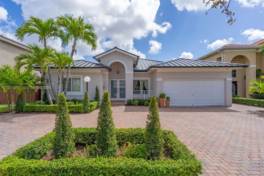 A rare opportunity to own in one of the area's most desirable private gated communities with an exceptionally low $220/month HOA. Stunning 3BD/2.5BA residence surrounded by lakes and lush greenery. Designed with soaring ceiling heights from 9’ to 11’, creating a bright and airy feel throughout. Impact windows and doors plus a brand-new metallic roof installed in Dec 2025, offering peace of mind for years to come. Modern kitchen with quartz countertops, waterfall-edge island and full quartz backsplash. Updated bathrooms with frameless glass shower and dual vanities. Curated landscape design, expansive covered terrace and oversized paved patio. Large driveway with plenty of parking and 2-car garage. Homes in this community rarely become available. Residents enjoy resort-style amenities including tennis and pickleball courts, a fitness center and a community pool.