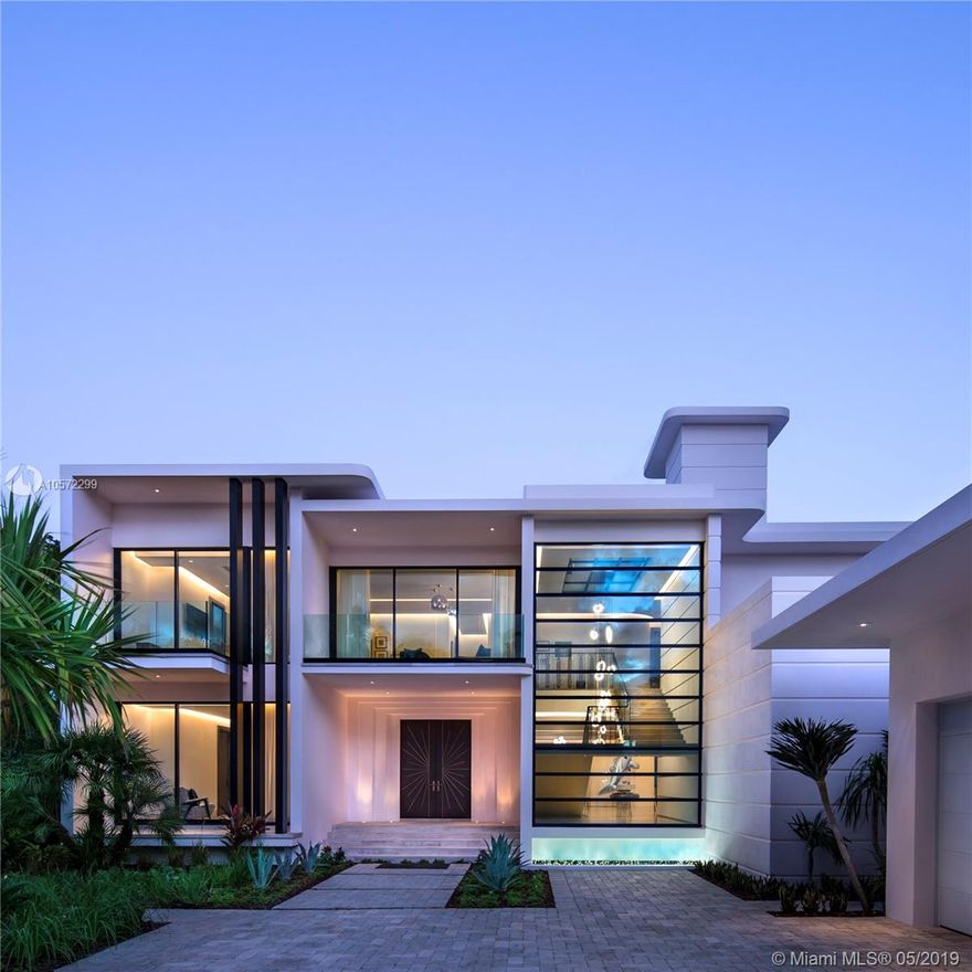 A Design Story. Perfectly located, offering safety & privacy on an exclusive island situated just steps away from top shops & restaurants. An elegant & modern masterpiece with its dynamic use of bespoke materials and close attention to detail. As you step through the gates of this new property the view unveils a stunning asymmetrical facade, oversized windows & a unique Art Deco inspired design. Surrounded by lush landscaping, this home is nestled on a large lot & offers 150ft of premium waterfront. The high quality craftsmanship is seen throughout the entire home from its innovative curved glass to its silk georgette marble flooring with inlay bronze metalwork. Experience indoor-outdoor living at its finest with sliding doors that open to an expansive pool deck overlooking the water.