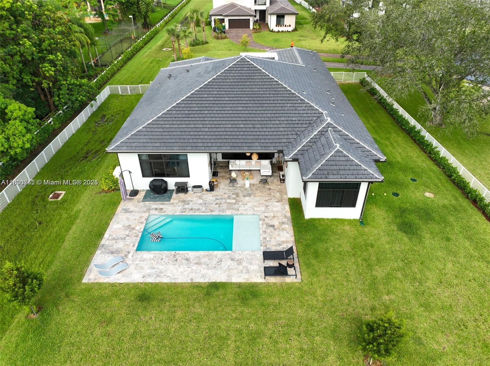 Beautiful 4BR/4.5 BA home on a full 1-acre lot in desirable Southwest Ranches! This spacious one-story property features an open floor plan, high ceilings, tile floors, and an upgraded kitchen with Calacatta marble countertops and stainless steel appliances. The primary suite offers patio access and a spa-like bath. Enjoy a pool, covered patio, and pergola—perfect for entertaining. Plenty of parking, impact windows/doors, and zoned for A+ schools. Minutes from Weston, I-75, and Pembroke Pines. Could be rented furnished. Pets welcome with approval!
